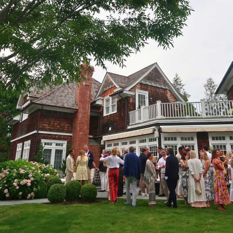 Guests gathered at a Hamptons garden party